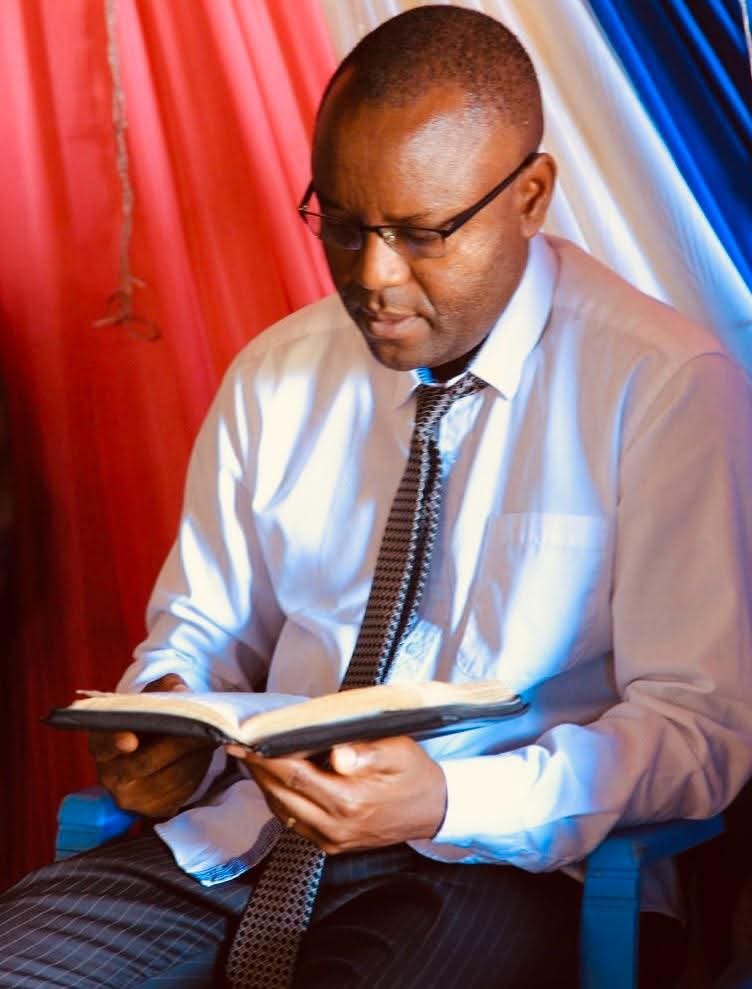 Pastor Fidele Bolton holding a Bible